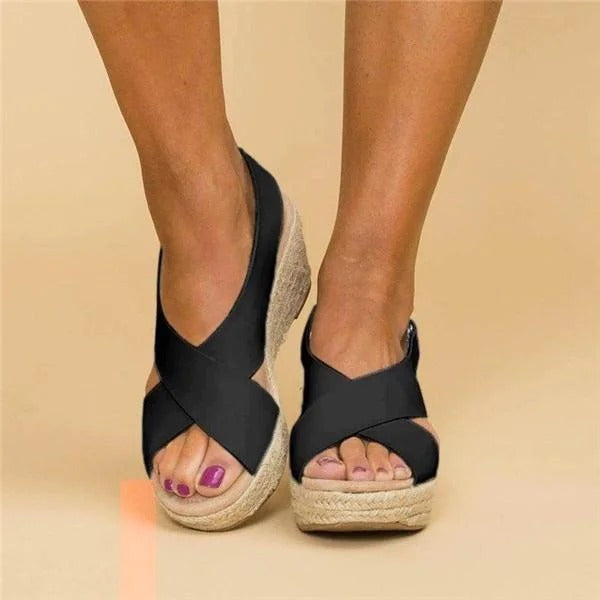 Women's black leather orthopedic espadrille wedge sandals with adjustable cross straps and jute-wrapped sole.