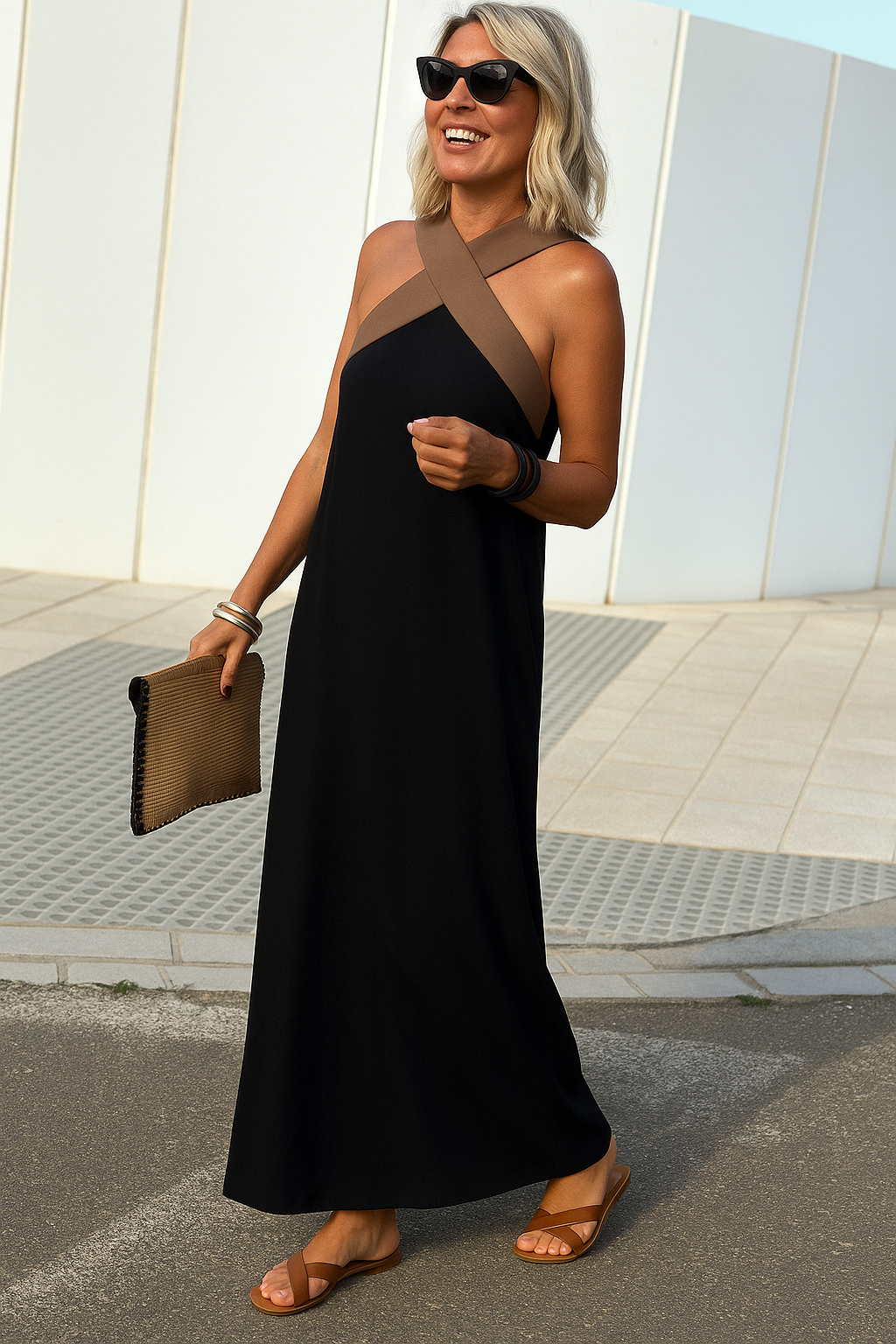 Elsie black maxi dress with a flattering crossover neckline, flowing silhouette, and brown halter straps.