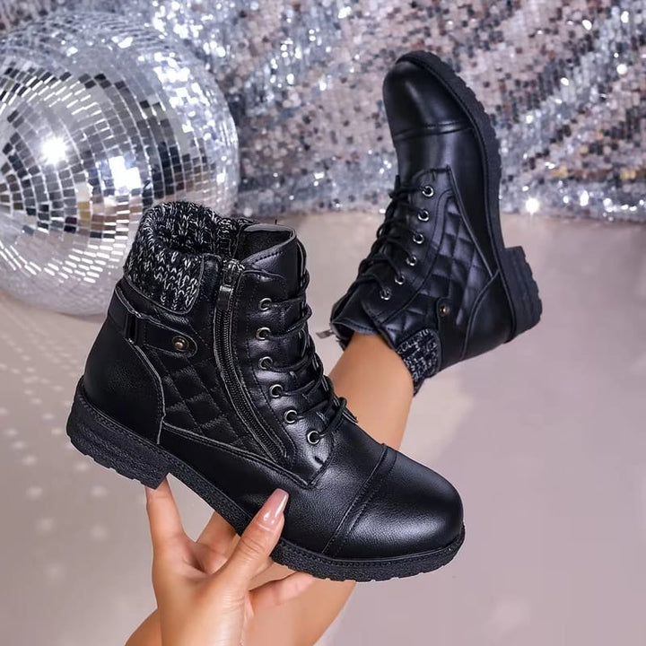 Black faux leather ankle boots featuring quilted panels, a cozy knitted collar, lace-up front, and a chunky block heel.