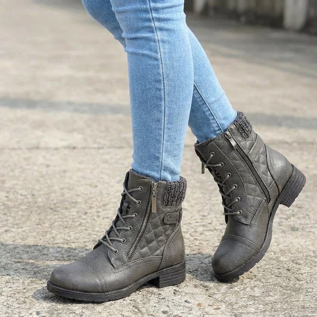 Grey faux leather ankle boots with quilted panels, knitted collar, lace-up front, and side zip on a chunky block heel.