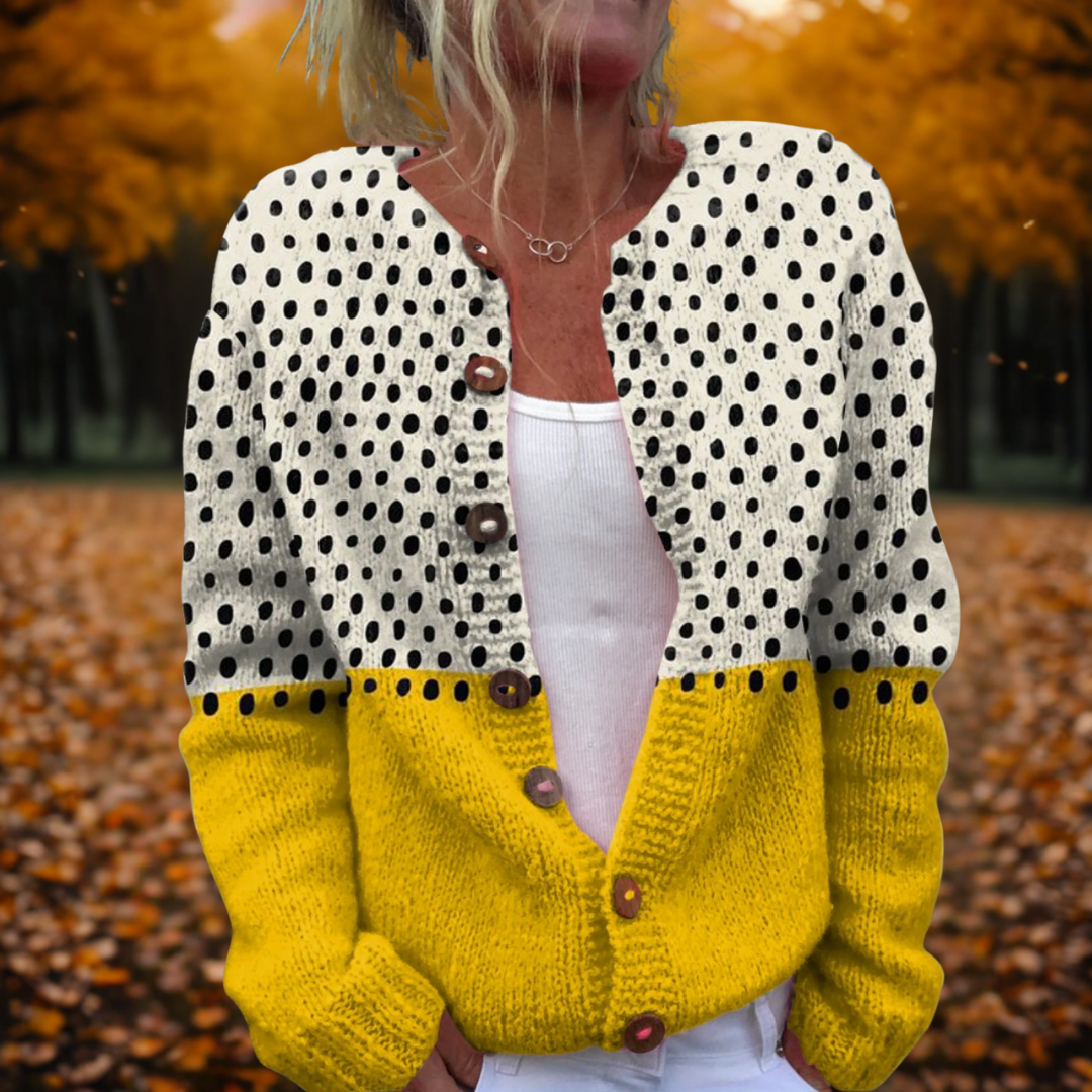 Women's cosy knit cardigan with a white polka dot top, yellow colour-blocked hem, and wooden button-through front.