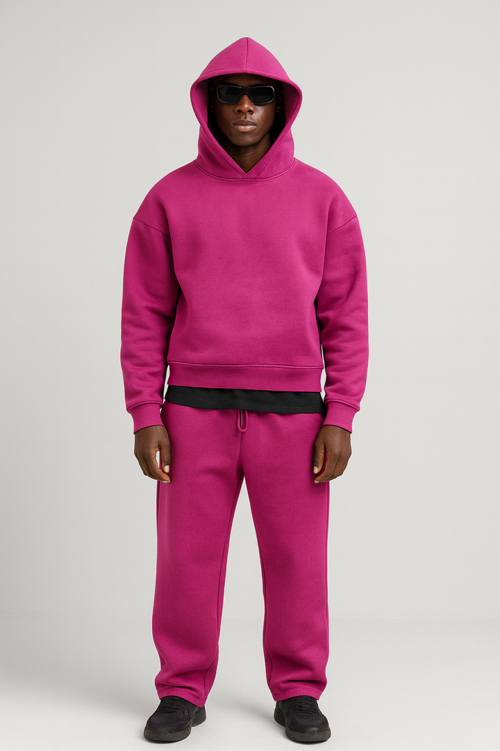 Man wearing a vibrant magenta cotton hoodie and matching drawstring joggers set.