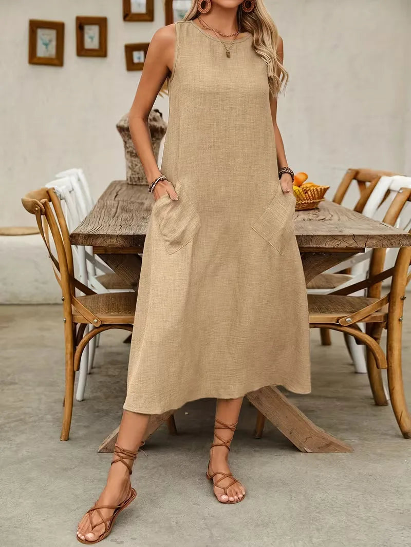 Etta women's sleeveless A-line midi dress in textured beige with a round neckline and practical front pockets.