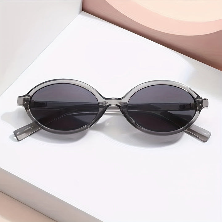 Evelyn women's retro oval sunglasses with slim grey frames and dark tinted lenses for everyday sun protection.
