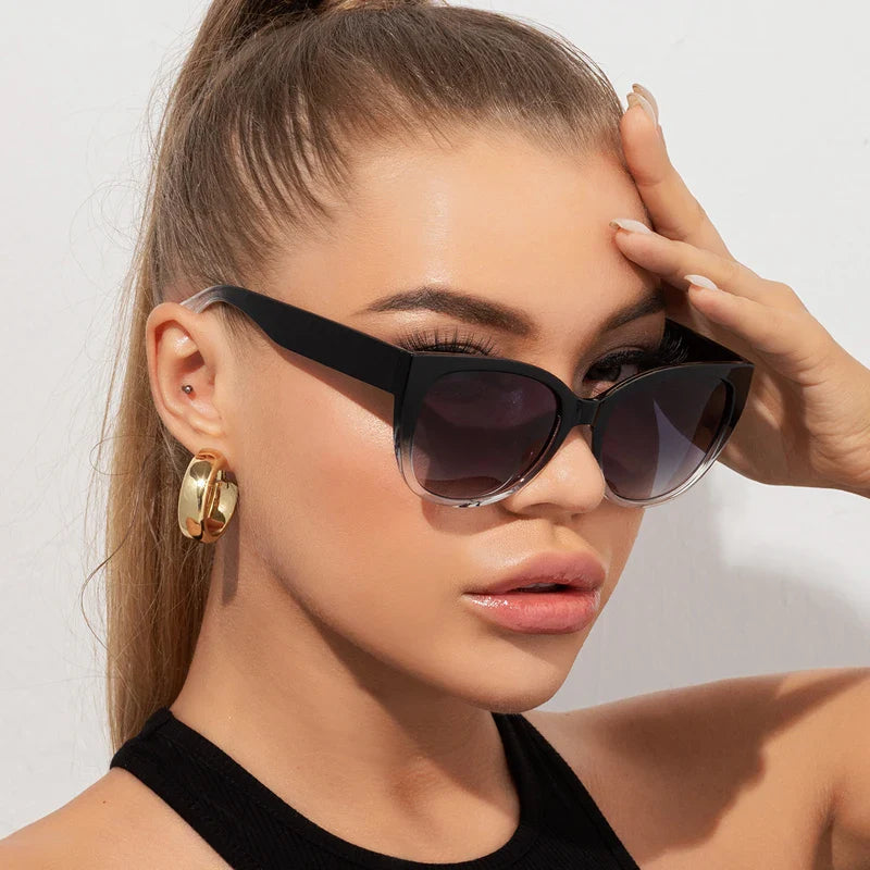 Faye women's butterfly gradient sunglasses with black-to-clear frames and wide temples.