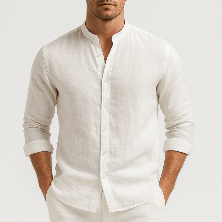Man wearing a white, long-sleeve linen shirt with a modern grandad collar and relaxed fit.