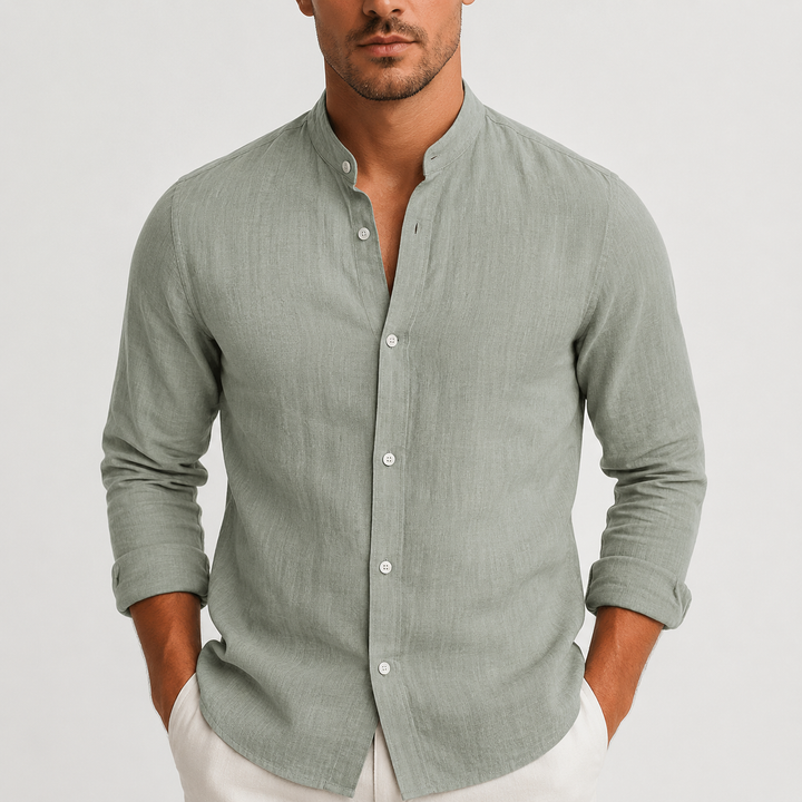 Sage green linen shirt with a grandad collar and button-up front, worn with a relaxed fit.