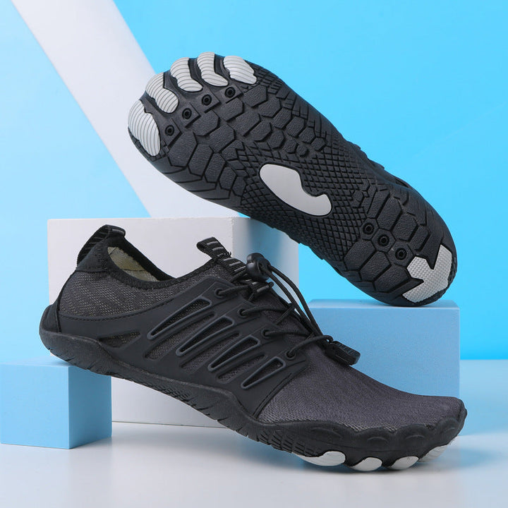 Black lightweight barefoot walking shoes with a flexible quick-dry mesh upper, bungee lace closure, and a grippy rubber sole.