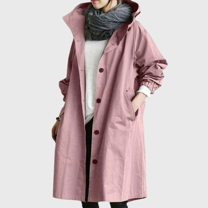 Dusty pink oversized waterproof raincoat with a hood, button-front closure, and deep side pockets.