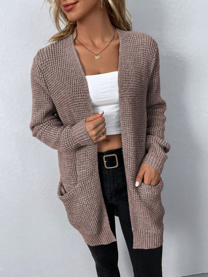 Cozy taupe waffle-knit cardigan with an open front, relaxed fit, and convenient side pockets for effortless layering.