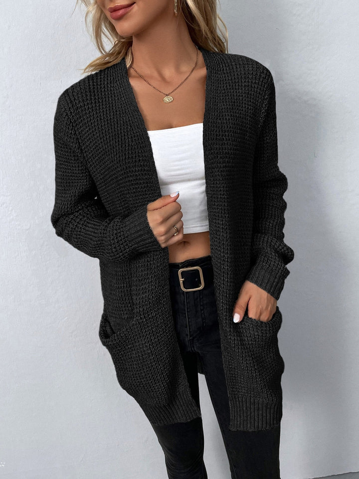 Black waffle-knit open-front cardigan with a relaxed fit, collarless design, and convenient side pockets.
