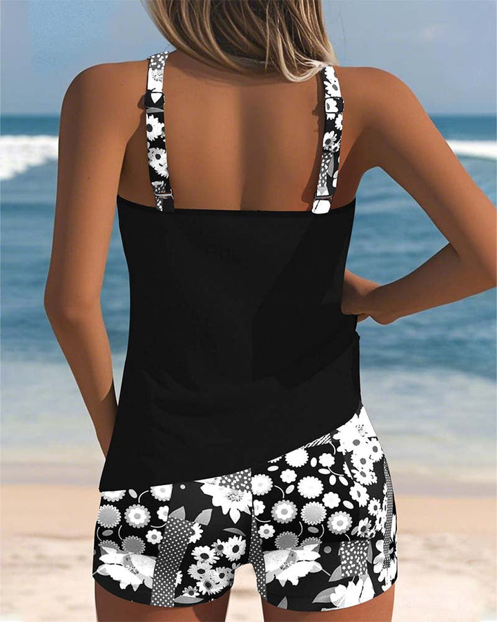 Women's Freya black tankini top with white floral print shorts, perfect for beach or pool.