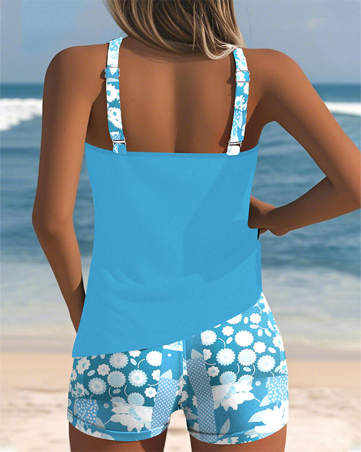 Freya women's blue tankini top with adjustable floral straps and coordinating floral print shorts for easy swim coverage.