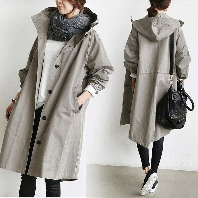 Oversized grey longline windbreaker jacket with a drawstring hood, button-front closure, and elasticated cuffs.