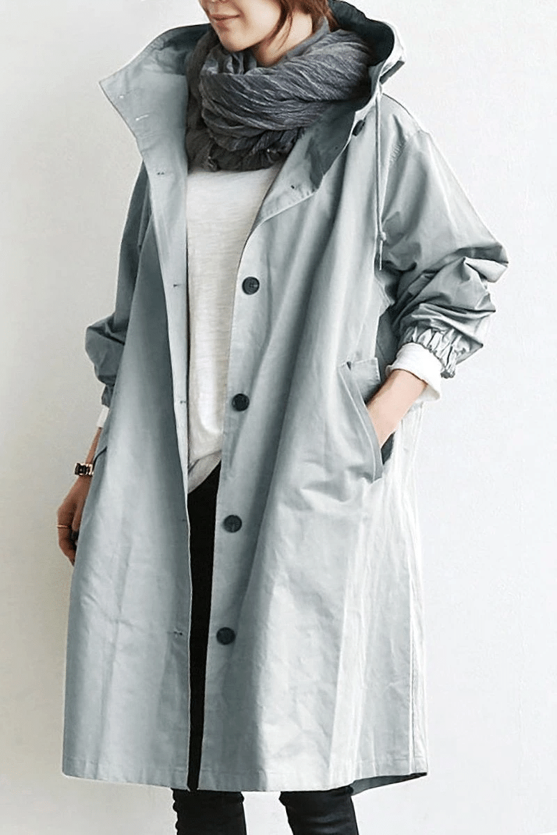 Oversized light grey longline windbreaker jacket with a drawstring hood, button-front closure, and elasticated cuffs.