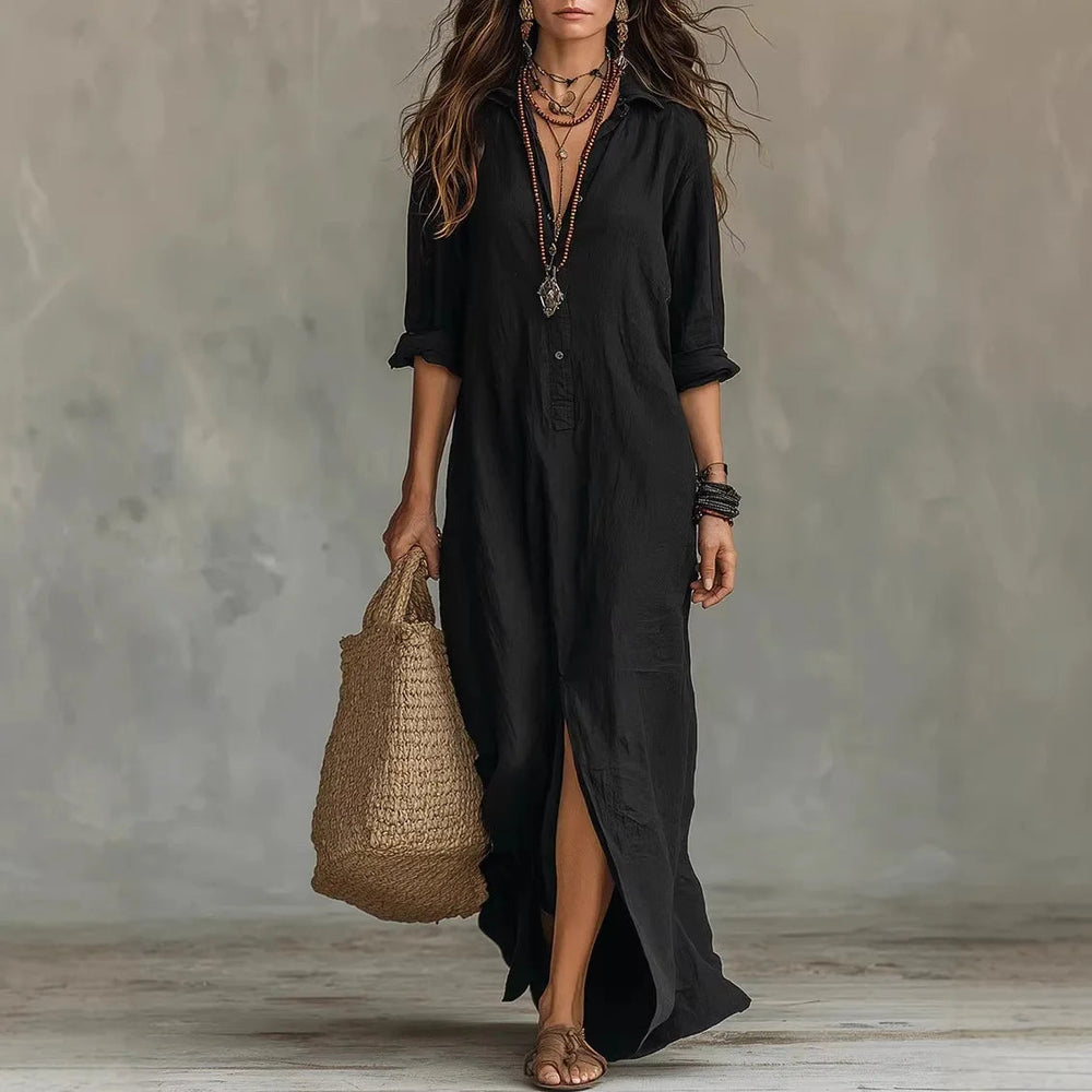 Black linen maxi shirt dress with a collared neckline, three-quarter sleeves, and a side-split hem.