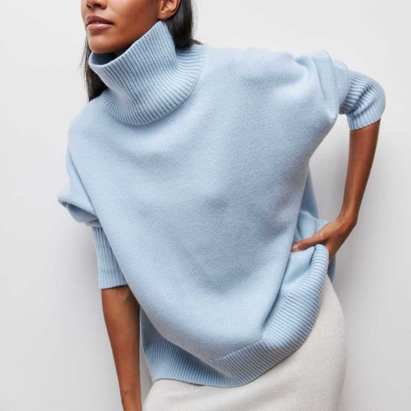 Light blue oversized turtleneck jumper with dropped shoulders and ribbed knit trim in a soft, cozy silhouette.