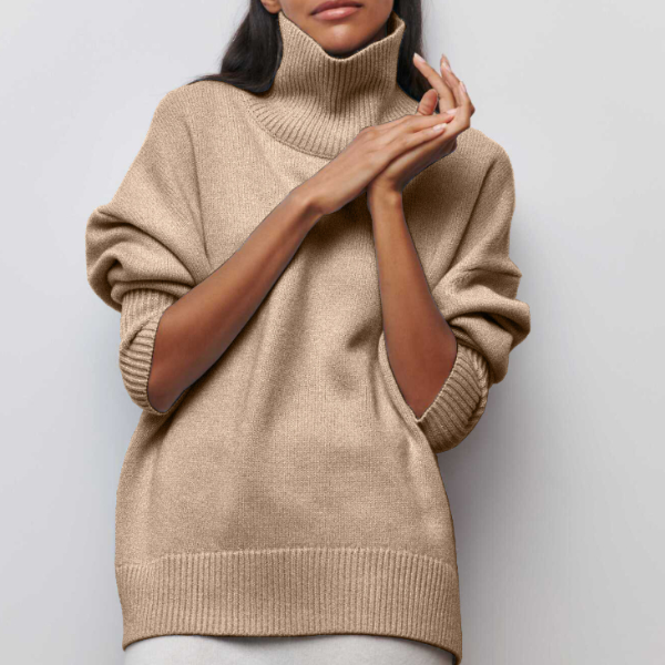 Beige oversized turtleneck jumper with dropped shoulders and ribbed cuffs in a soft, cozy knit fabric.