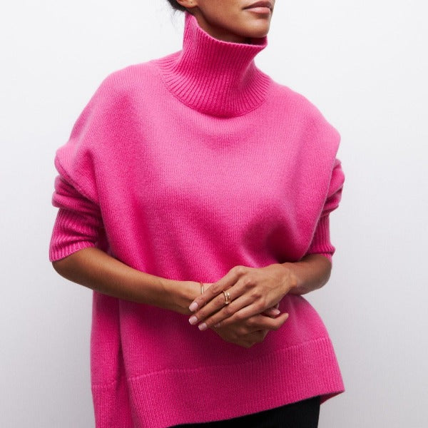 Bright pink oversized turtleneck jumper with dropped shoulders and ribbed knit detailing in a cozy, relaxed fit.