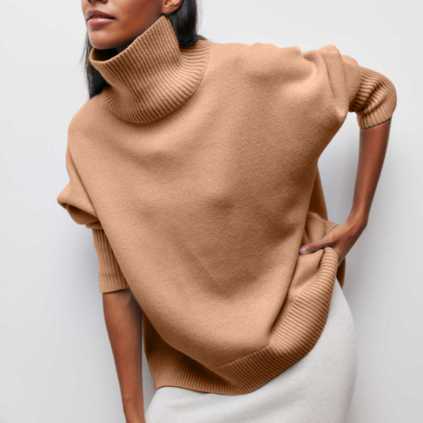 Camel-colored oversized turtleneck jumper with dropped shoulders and ribbed knit trim in a relaxed, cocoon silhouette.