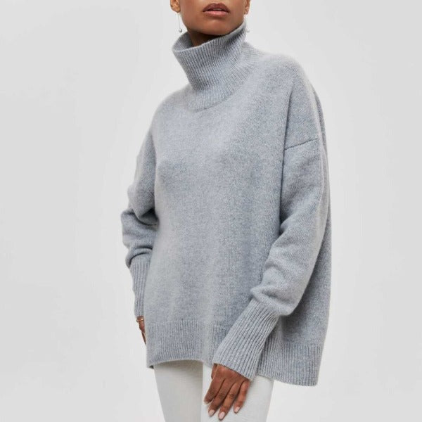 Grey oversized turtleneck jumper with dropped shoulders and ribbed cuffs in a soft, cozy knit fabric.