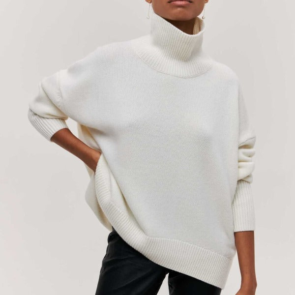 Cream oversized turtleneck jumper with dropped shoulders and ribbed cuffs in a soft knit fabric.