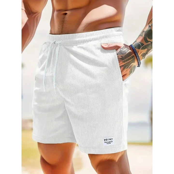 White textured drawstring shorts with side pockets and a small branded patch on a relaxed, casual fit.
