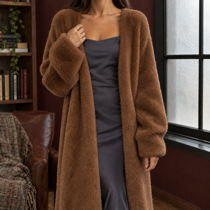 Woman wearing a plush, brown longline knit cardigan with a relaxed open-front design and voluminous sleeves.