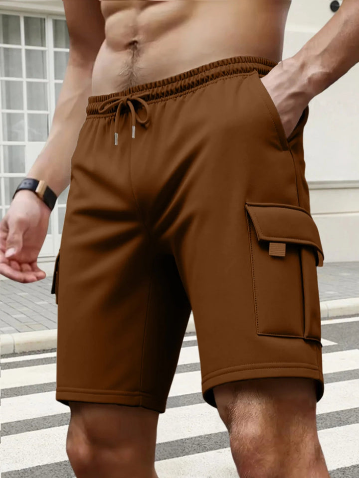 Brown men's knee-length cargo shorts with an elastic drawstring waist and side flap pockets for practical storage.