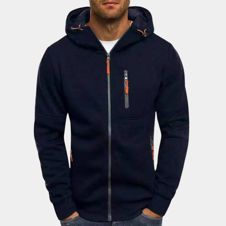 Men's navy blue zip-up hooded jacket with contrast orange drawcords and zipper pulls, featuring a chest pocket.