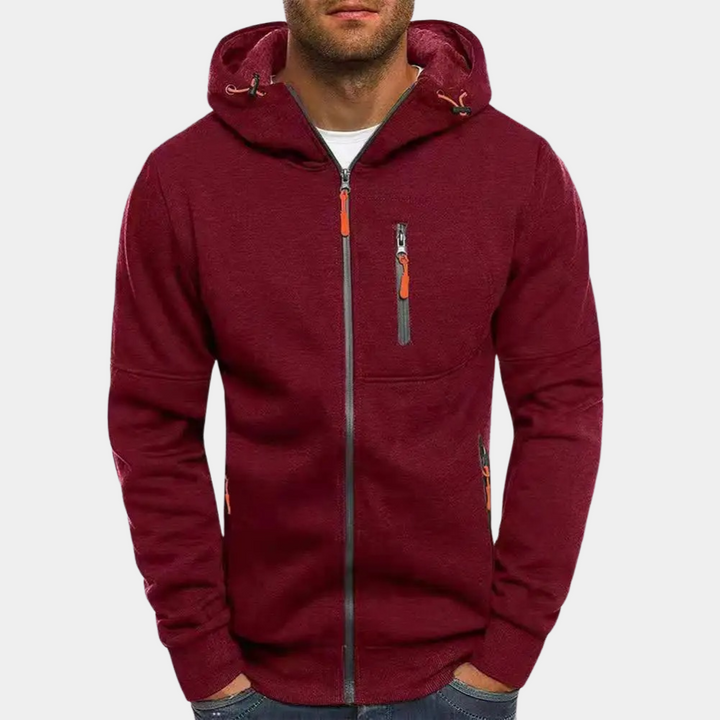 Burgundy men's zip-up hoodie with an adjustable drawcord hood, contrast orange zipper pulls, and multiple zip pockets.