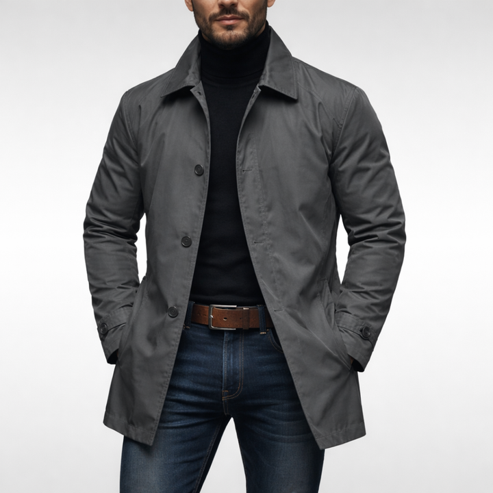 Men's grey lightweight, water-resistant windproof jacket with a point collar and button front, styled over a black turtleneck.