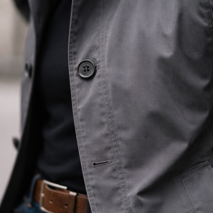 Grey lightweight windproof jacket featuring a smart button-front design and water-resistant finish for a polished urban look.