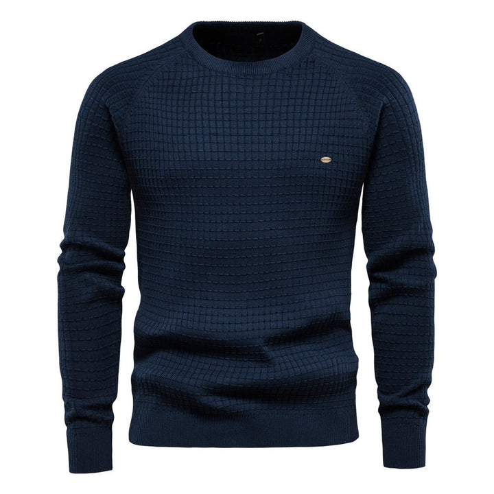 Navy blue men's crew neck jumper with a textured waffle knit, raglan sleeves, and ribbed trims.