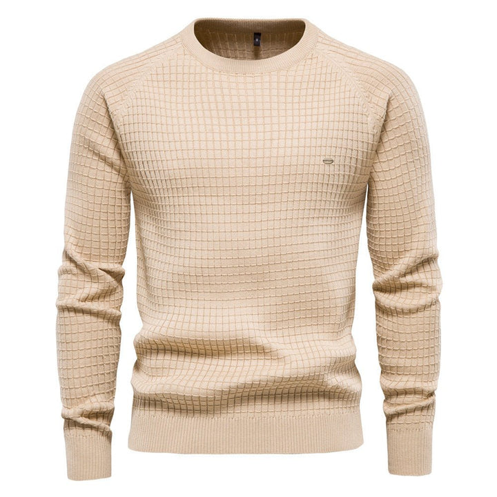 Beige men's crew neck jumper in a waffle-textured knit with raglan sleeves and ribbed cuffs, hem, and neckline.