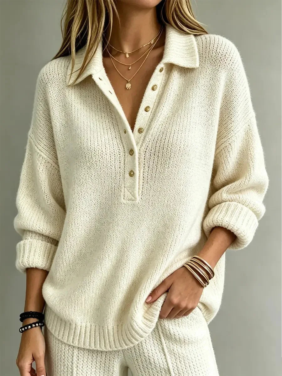 Cream-colored knit polo jumper featuring a pointed collar, partial button placket, dropped shoulders, and ribbed trim.