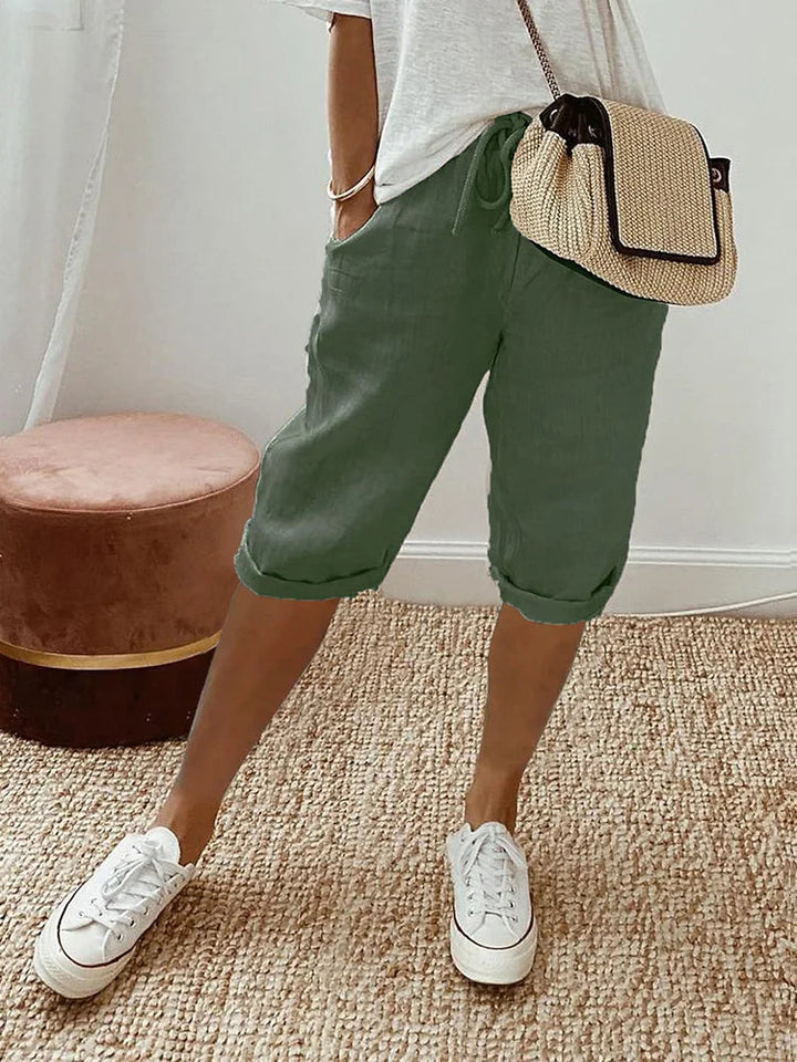 Women's Georgia linen drawstring shorts in olive green, featuring side pockets and a cuffed hem.