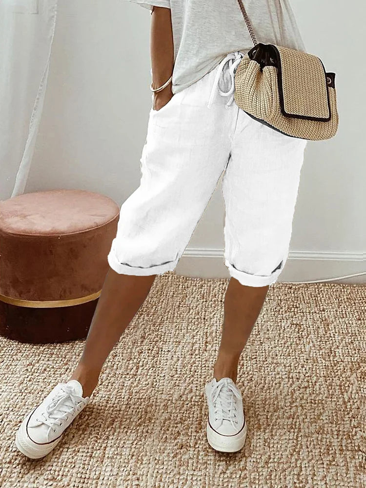 White linen drawstring shorts with rolled cuffs, side pockets, and a relaxed fit for effortless daily dressing.