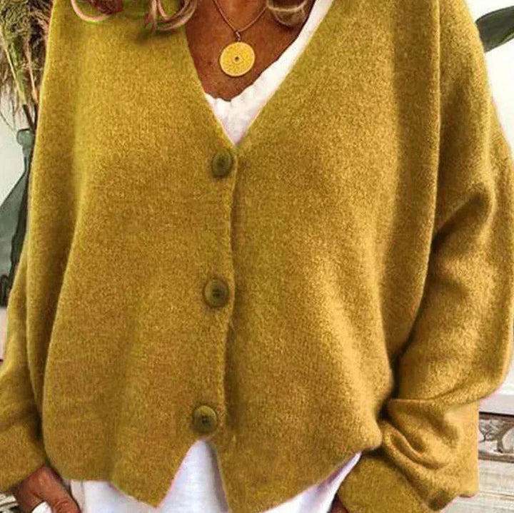 Mustard yellow V-neck knit cardigan with a button-front closure and relaxed, soft-textured fit.