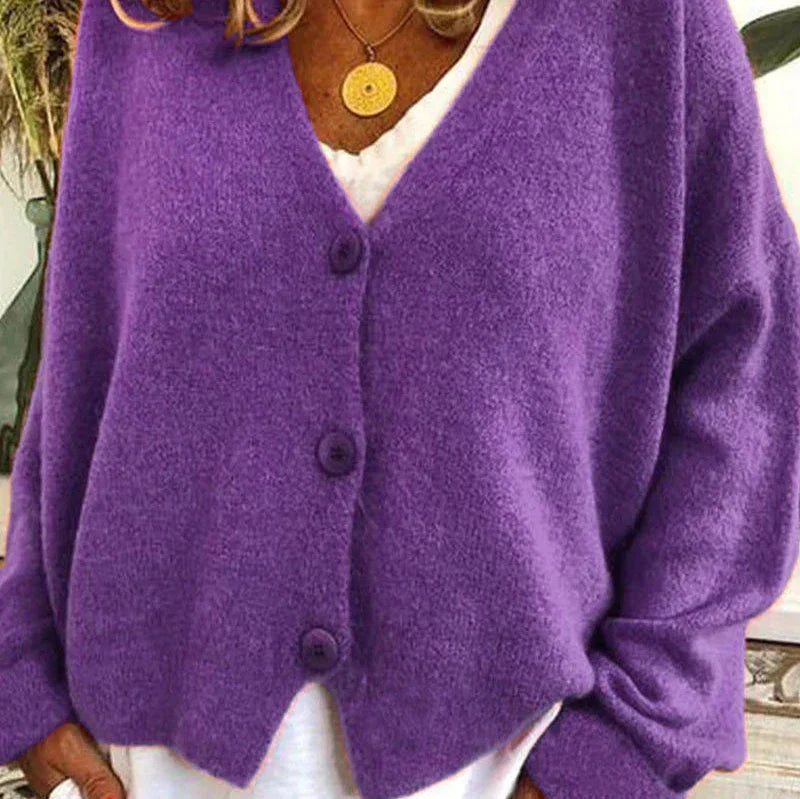 Soft purple knit V-neck cardigan with a button-front closure and relaxed fit worn over a white top.