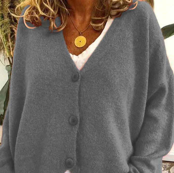 Soft grey V-neck knit cardigan with a button-front closure and relaxed, comfortable fit.