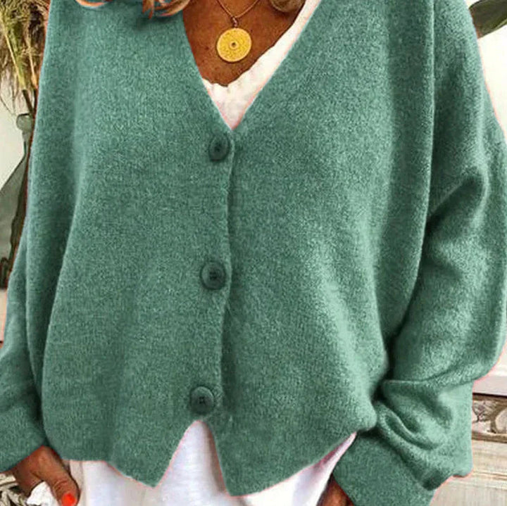 Soft teal green knit V-neck cardigan with a button-down front and relaxed, comfortable fit.