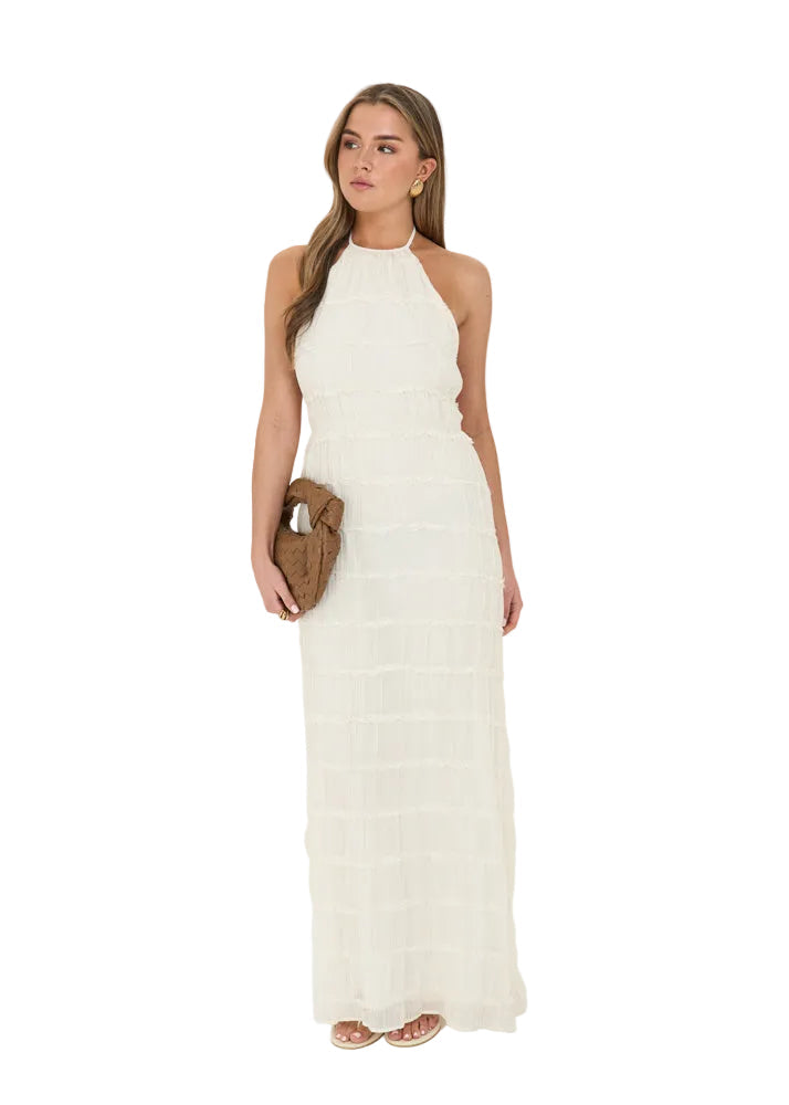 Cream-colored halter maxi dress in textured, tiered fabric with a slim, ankle-length silhouette.
