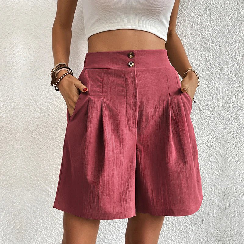 High-waisted dusty rose pleated shorts with a double-button waistband, wide-leg fit, and deep side pockets.