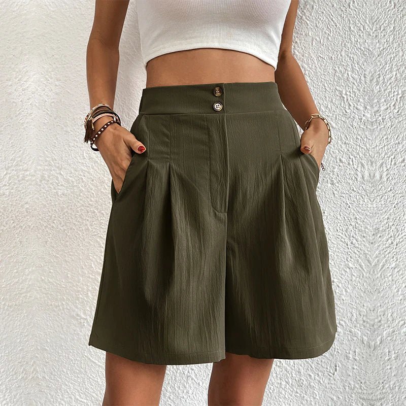 Olive green high-waisted pleated shorts with a double-button waistband and side pockets.