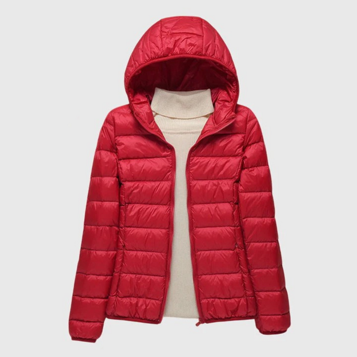 Women's red lightweight quilted hooded jacket with a full-length zip, layered over a cream turtleneck sweater.