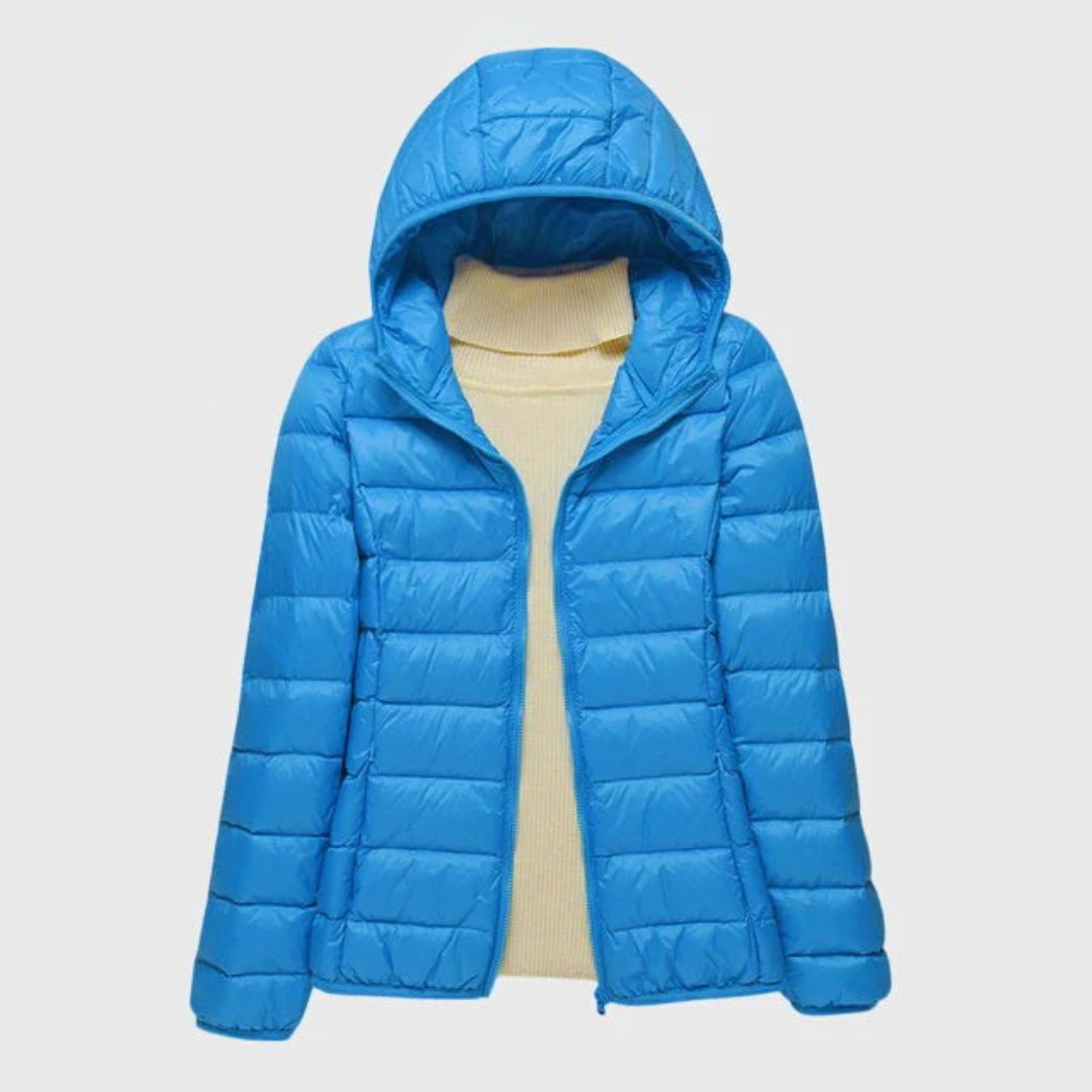 Bright blue lightweight quilted hooded jacket with a full-length zip, layered over a cream ribbed turtleneck sweater.