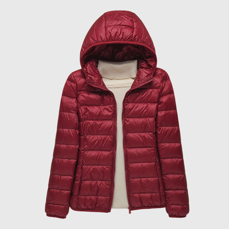 Women's lightweight burgundy quilted hooded jacket with a full-length zip and slim, layer-friendly silhouette.