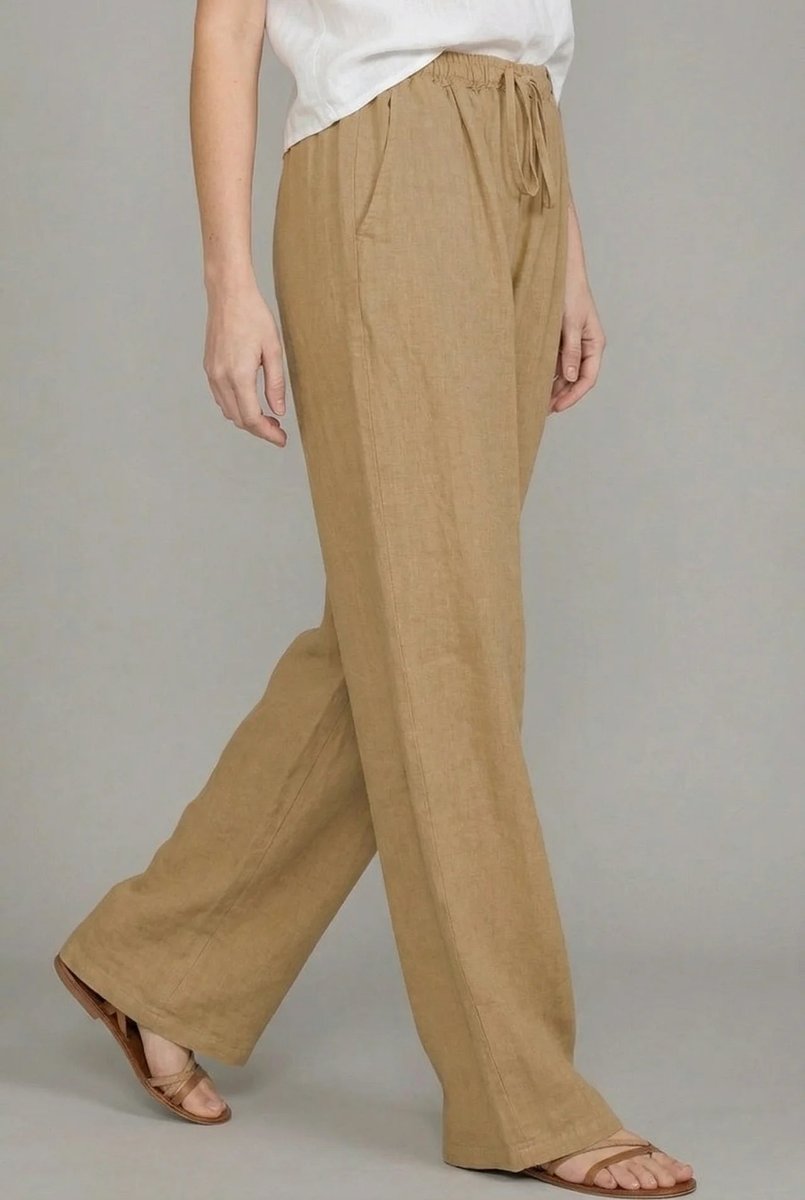 Tan linen wide-leg trousers with an elasticated drawstring waist and side pockets, styled for a relaxed fit.