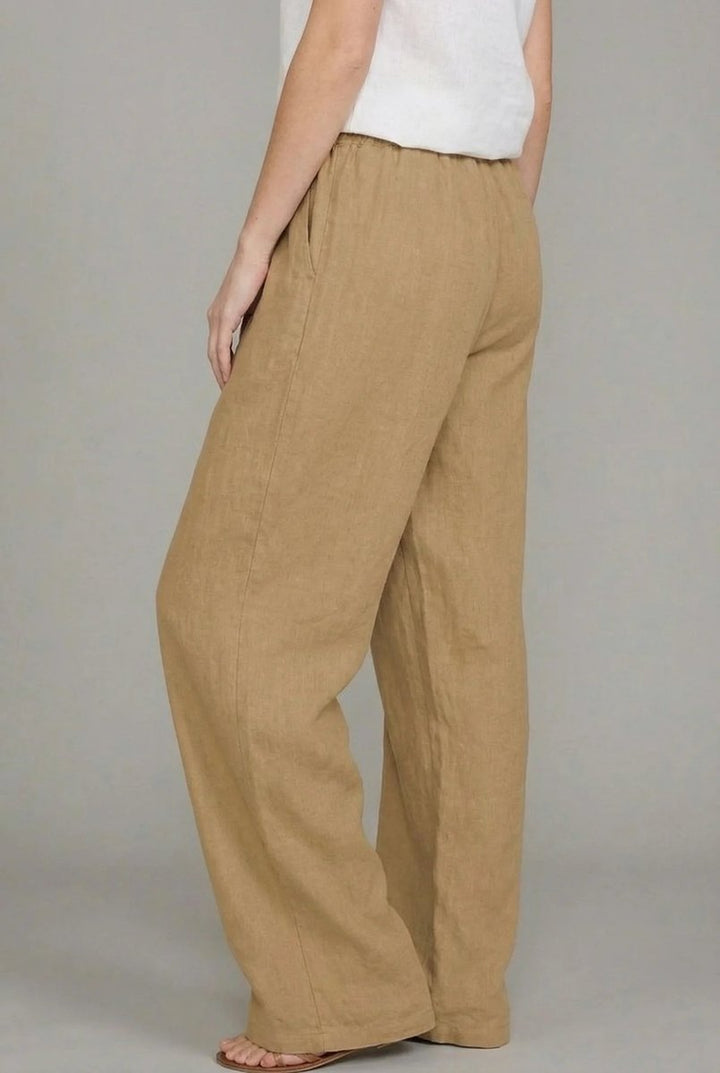 Tan linen wide-leg trousers with an elasticated drawstring waist and side pockets.